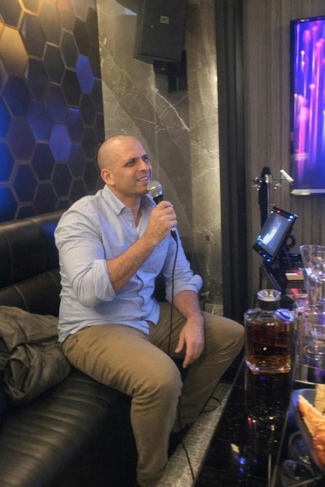 AI photo of a man singing karaoke at a nightlife lounge