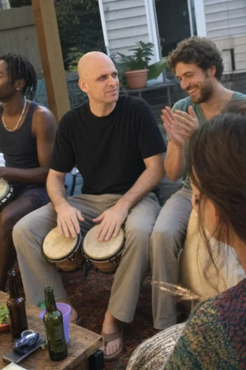 AI dating photo example: playing bongos in a living room