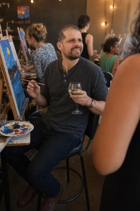AI dating photo example: with a glass at a paint-and-sip night