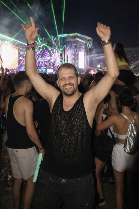 AI dating photo example: arms up at a rave