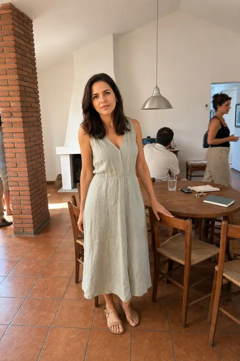 AI photo example for women: in a sunlit kitchen in a linen dress